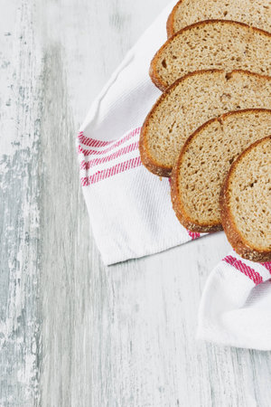 sliced rye bread in a basket on a light wooden background. health and diet food