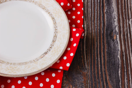 vintage plate on red kitchen towel on wooden background. kitchen utensilsの写真素材