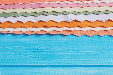 cloth napkins in different colors on a blue wooden background. backgrounds and textures. copy space for you textの写真素材