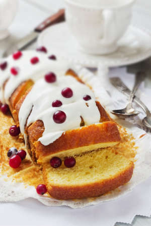 arge sliced cupcake with white frosting and fresh cranberries on the holiday table. holiday meal. selective focusの写真素材