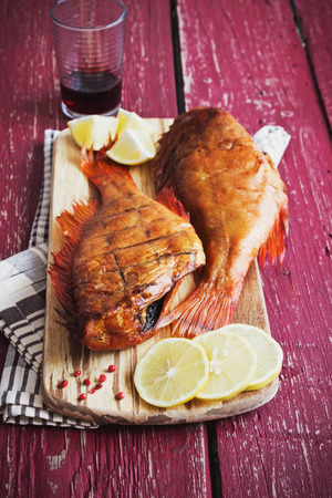 lunch of smoked sea bass and vegetables on  wooden background.  food of the useful seafood. health...