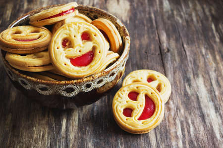 biscuits with jam in a bowl on the old wooden background. sweet pastries. close-upの写真素材