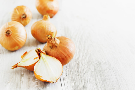 onions on old wooden background.の写真素材