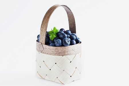 fresh blueberries in a basket on a white background. の写真素材