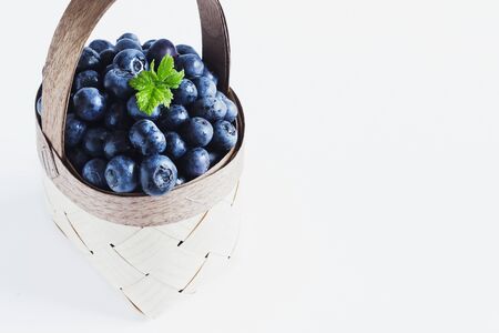 fresh blueberries in a basket on a white background. の写真素材