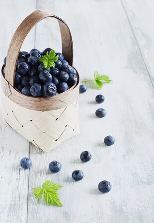 fresh blueberries in a basket on a white background. の写真素材