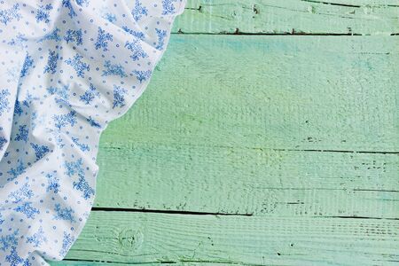 white tablecloth on a green wooden background. backgrounds and texturesの写真素材
