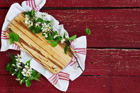 cutting board and branches with flowers on the old wooden background. top view. copy space backgroundの写真素材