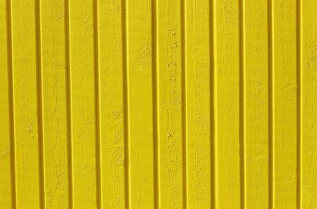 wooden planks painted yellow background. copy space backgroundの写真素材