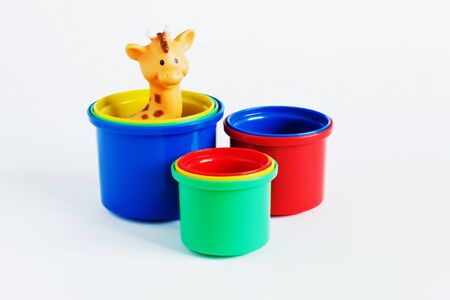 colored plastic cups for children's sandbox on a white background. educational toys for preschoolersの写真素材