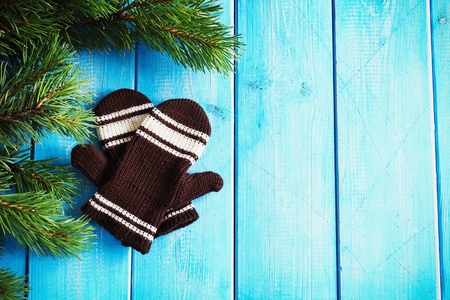 children's knitted mittens on a blue wooden background. copy space backgroundの写真素材