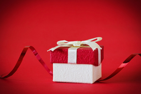 gift box with ribbon on a red background. festivals and events. selective focus