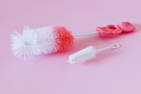 brush for washing dishes on a colored background. kitchenware. selective focus