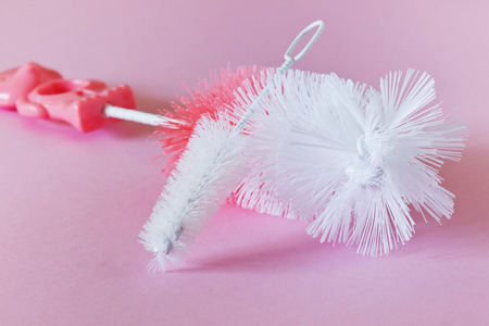 two brush for washing dishes on a colored background. kitchenware. selective focusの写真素材