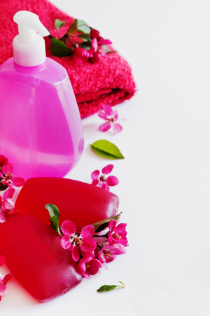Glycerin soap bars and liquid soap in a bottle with floral aroma on a white background. Health care and hygiene concept. Selective focusの写真素材