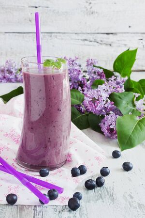 fresh smoothie with blueberries in a glass on a white wooden background. ripe blueberries. health and diet  beverage. selective focusの写真素材