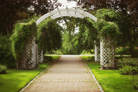 Wooden arch. Entrance to the city park. City attractions. Toned image