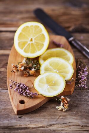 Lemon and dry flower tea on a wooden background. Bio healthy food and drink. Healthy lifestyle. Selective focusの写真素材