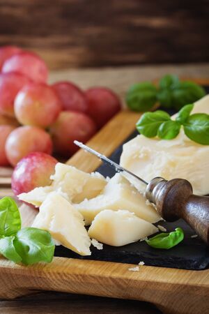 Fresh parmesan cheese and ripe grapes on a table. Health and diet food. Selective focusの写真素材