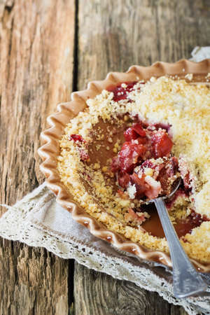 Plum crumble in a plate on the table. Traditional English cuisine. Selective focusの写真素材