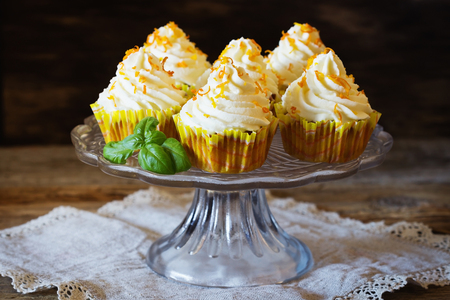 Delicious homemade cupcakes and oranges on the wooden background. Selective focusの写真素材