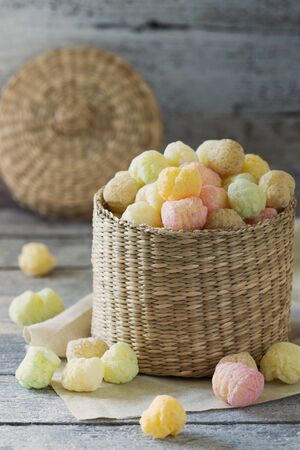 Colored crispy corn balls in a basket on a wooden background. Healthy eating Close-upの写真素材