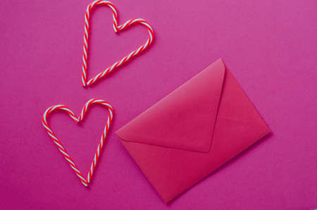 Festive pink background. Hearts of sweet candies with envelope. Love. Valentine's Day. 14 of...