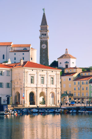 Scenic view of red roofs of the historical center of old town Piran with Tartini Square against the sunrise sky and Adriatic sea. Aerial view, coast of Slovenia.のeditorial素材