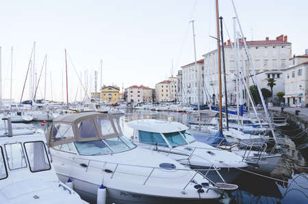 Scenic view of narrow empty streets of historical center of old town Piran against the sunrise sky...