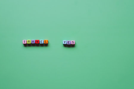 Creative ideas of summer travel, holiday concept. Top view of cube beads with words Travel, Yes...