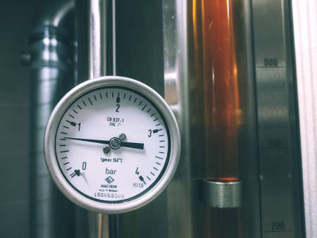 Modern brewery production steel tanks and pipes, machinery tools and vats. Fermentation of beer. Beer preparation, brewery equipment, close-up.のeditorial素材