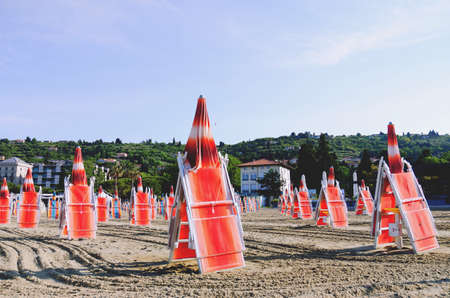 PortoroÅ¾, Slovenia. 09/06/2021. Sun beds and umbrellas on a beautiful tropical beach at the Adriatic coast in Slovenia. Leasure at the beach. Travel concept.のeditorial素材
