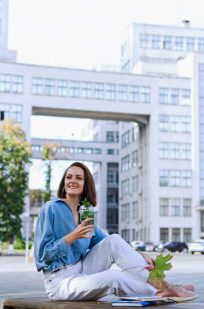 Urban portrait of young elegant business woman in eye glasses and casual clothes. Woman walking in...