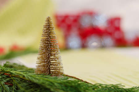 Christmas and New Year background with pine branches, decorations and toy Christmas tree. Flat lay, top view. New Year gifts.の写真素材