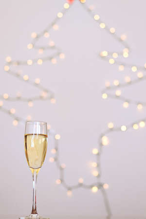 Two glasses of wine with bokeh background close up. Top view. New Year, Christmas mood. Greeting card. Party and holiday celebration concept.の写真素材