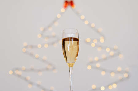 Two glasses of wine with bokeh background close up. Top view. New Year, Christmas mood. Greeting card. Party and holiday celebration concept.の写真素材