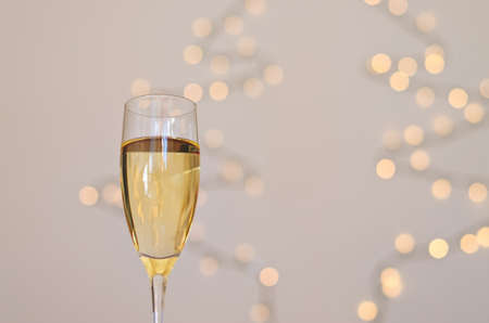 Two glasses of wine with bokeh background close up. Top view. New Year, Christmas mood. Greeting card. Party and holiday celebration concept.の写真素材
