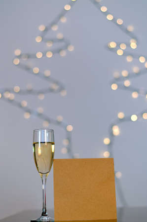 Two glasses of wine with bokeh background close up. Top view. New Year, Christmas mood. Greeting card. Party and holiday celebration concept.の写真素材