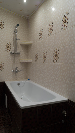 Modern bathroom made in light coffee and dark brown tones