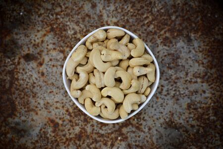 Tasty cashew nuts in bowlの写真素材
