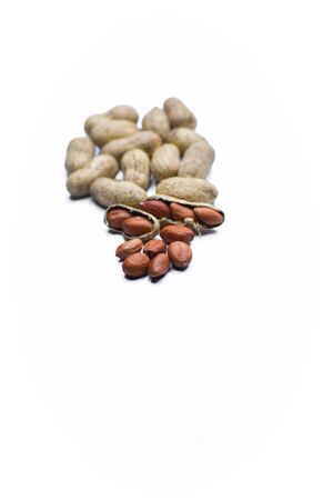 Close up view of shelled peanuts and cracked peanuts isolated on white background