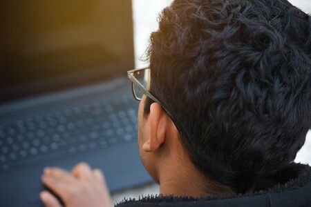 Young man working with laptop, business person at workplaceの写真素材