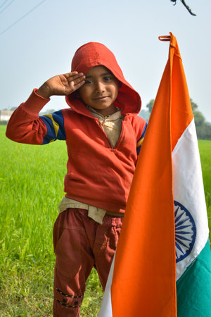TIKAMGARH, MADHYA PRADESH, INDIA - JANUARY 22, 2020: Unidentified indian village little boy holding indian flag.のeditorial素材