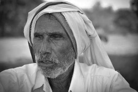 MADHYA PRADESH, INDIA - NOVEMBER 01, 2019: Black and white portrait of a Indian old man.のeditorial素材