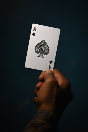 TIKAMGARH, MADHYA PRADESH, INDIA - DECEMBER 15, 2019: Hand holding ace of spades playing card.