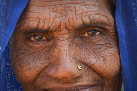 TIKAMGARH, MADHYA PRADESH, INDIA - FEBRUARY 08, 2020: Closeup shot of the eyes of an old indian woman staring at the camera.のeditorial素材