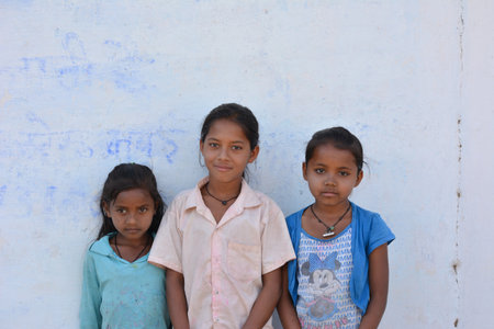 TIKAMGARH, MADHYA PRADESH, INDIA - MARCH 24, 2020: Group of happy Indian little village girls standing in front of their house.のeditorial素材