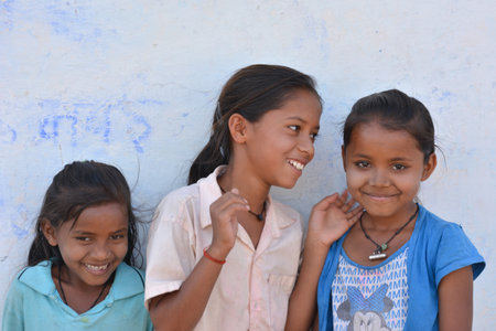 TIKAMGARH, MADHYA PRADESH, INDIA - MARCH 24, 2020: Group of happy Indian little village girls standing in front of their house.のeditorial素材