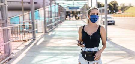 Woman in city street wearing face mask protective for spreading of Coronavirusの写真素材