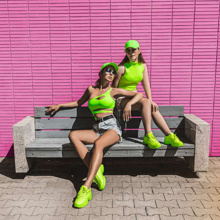 Fitness sport girls in fashion sportswear doing fitness exercise in the street, outdoor sports, urban style.の写真素材